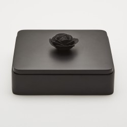 Boîte en bois noir surplombée d'une rose en porcelaine